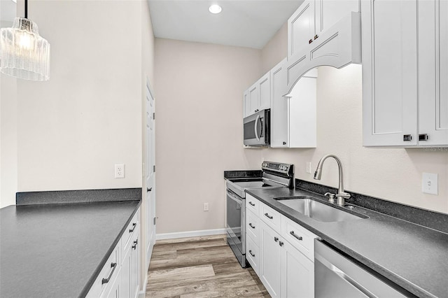 kitchen with sink, white cabinets, and appliances with stainless steel finishes