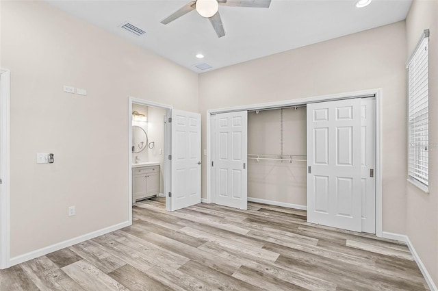 unfurnished bedroom with ceiling fan, a closet, and light wood-type flooring