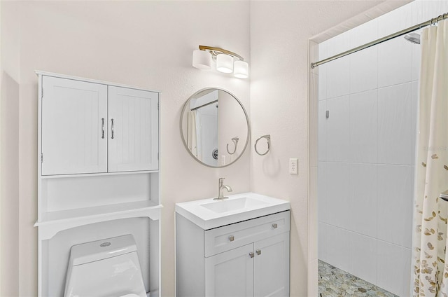 bathroom featuring toilet, walk in shower, and vanity