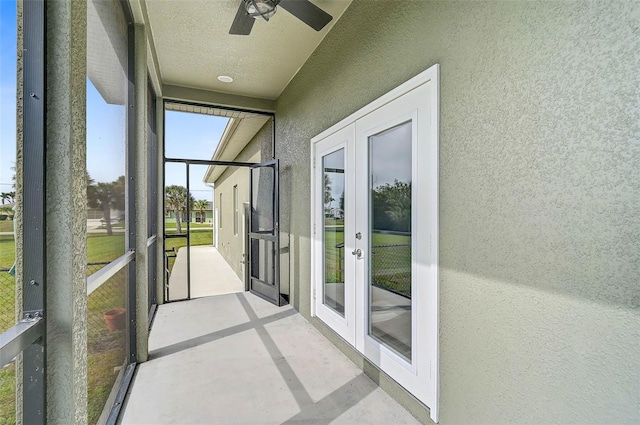 unfurnished sunroom with ceiling fan and french doors