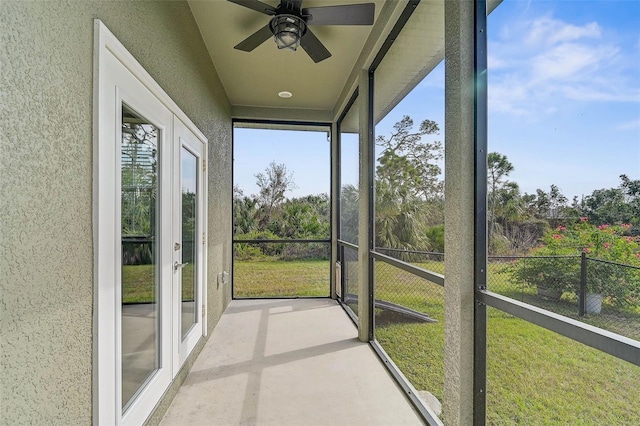 unfurnished sunroom with ceiling fan and french doors