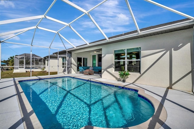 view of pool featuring a lanai, an outdoor living space, ceiling fan, and a patio area