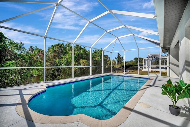 view of pool featuring glass enclosure and a patio