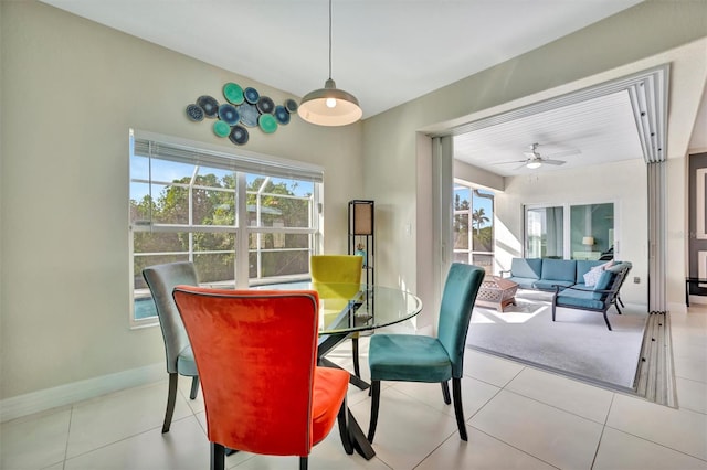 tiled dining area featuring ceiling fan