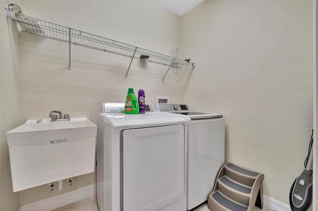 laundry room featuring separate washer and dryer and sink