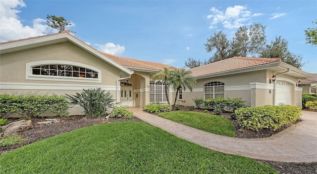 mediterranean / spanish-style house with a garage and a front yard