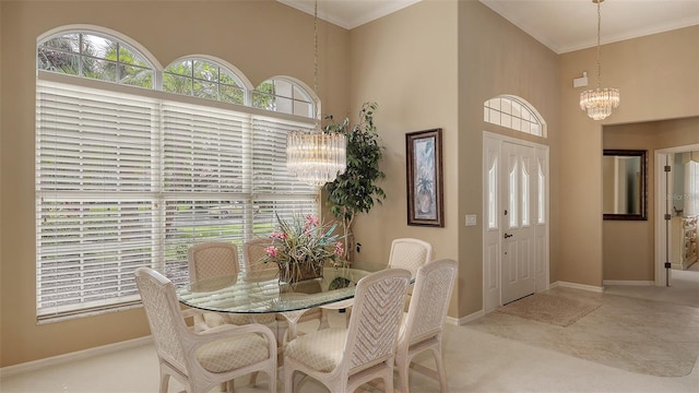 tiled dining room with a towering ceiling, an inviting chandelier, and ornamental molding