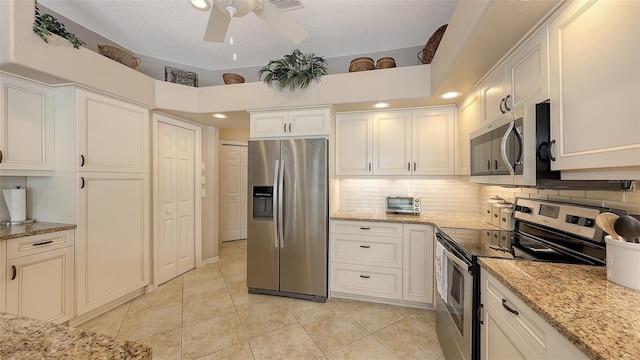275 Royal Oak Way, Venice, FL 34292 - kitchen with stainless steel appliances, light tile patterned flooring, backsplash, a ceiling fan, and light stone countertops