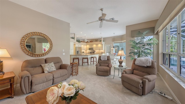 living room featuring ceiling fan and light colored carpet