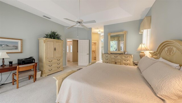 275 Royal Oak Way, Venice, FL 34292 - bedroom with light carpet, connected bathroom, vaulted ceiling, and a ceiling fan