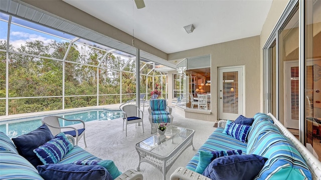 sunroom / solarium with ceiling fan and a swimming pool