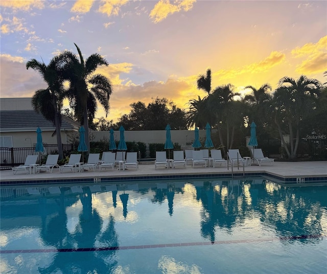 275 Royal Oak Way, Venice, FL 34292 - pool at dusk featuring a patio area and a community pool
