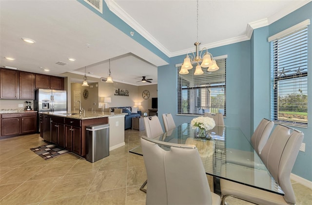 tiled dining room featuring ceiling fan with notable chandelier, crown molding, and sink