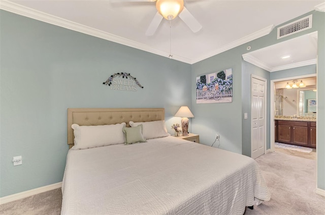 carpeted bedroom featuring sink, ceiling fan, crown molding, and ensuite bathroom