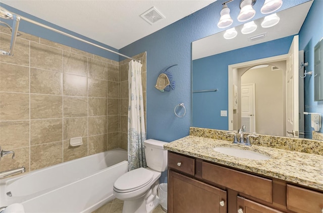 full bathroom with tile patterned floors, vanity, shower / tub combo, and toilet