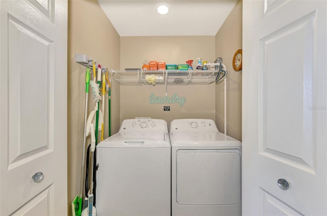 clothes washing area featuring washer and dryer