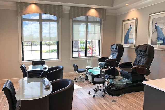 office space with light wood-type flooring and ornamental molding