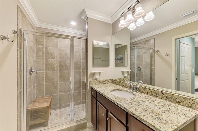 bathroom with vanity, an enclosed shower, and ornamental molding