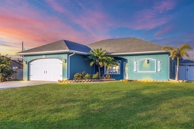 ranch-style home with a yard and a garage