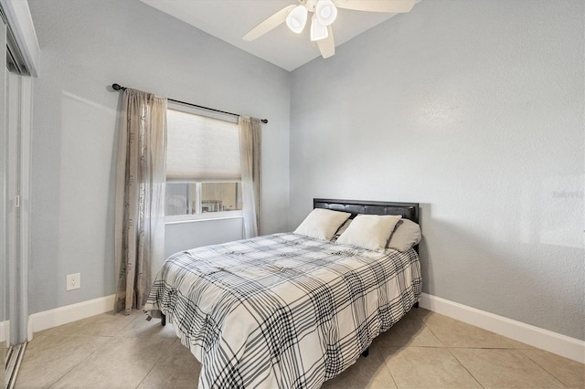 tiled bedroom with ceiling fan