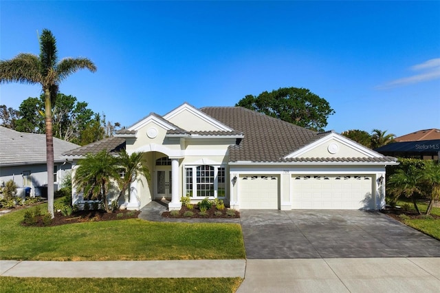 view of front of property featuring a garage and a front yard