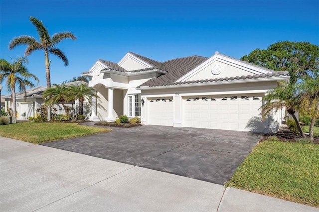 view of front of home with a front yard and a garage