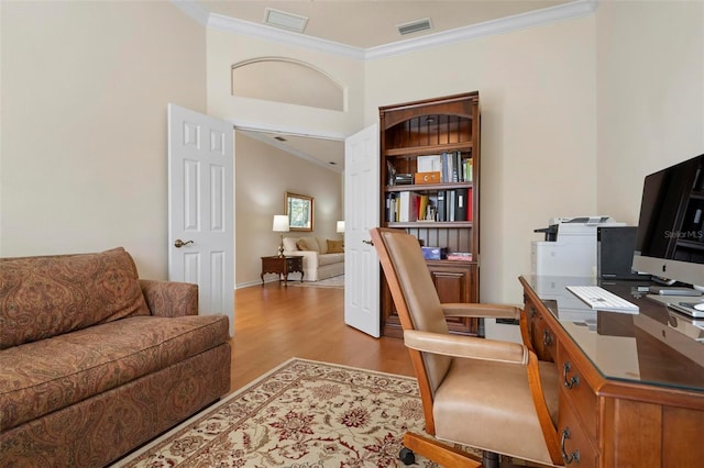 office space featuring light hardwood / wood-style floors and crown molding