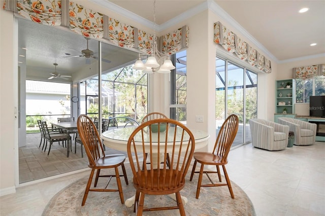 dining space featuring ceiling fan with notable chandelier, a wealth of natural light, and crown molding