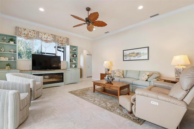 living room featuring ceiling fan and ornamental molding