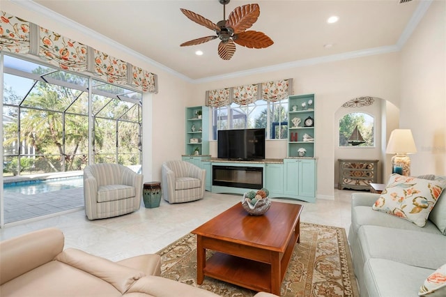 tiled living room featuring ceiling fan and crown molding