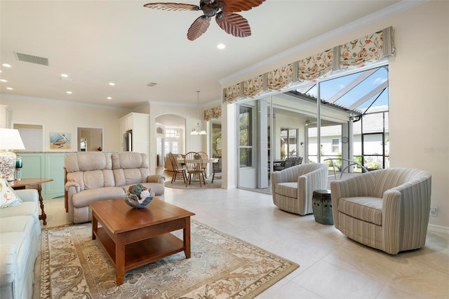 living room with ceiling fan and crown molding