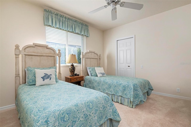 carpeted bedroom featuring ceiling fan and a closet