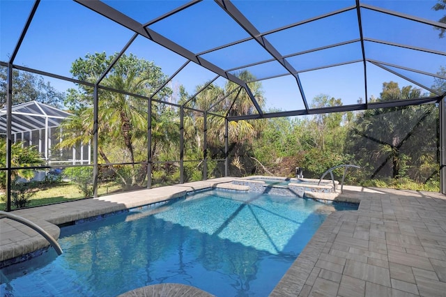 view of swimming pool with a patio area, a lanai, and an in ground hot tub