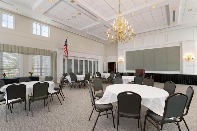 carpeted dining room with a chandelier, a towering ceiling, a wealth of natural light, and coffered ceiling