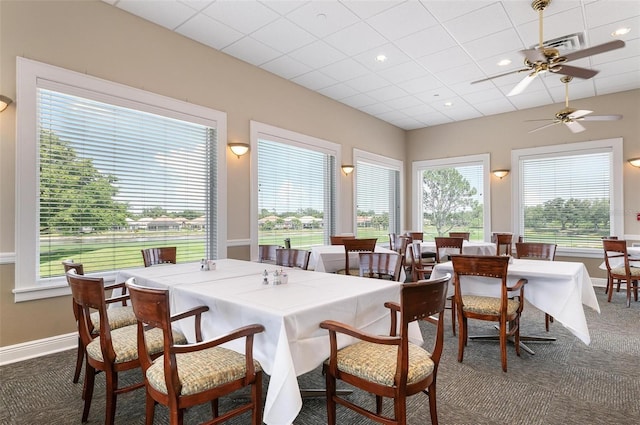 carpeted dining room featuring ceiling fan