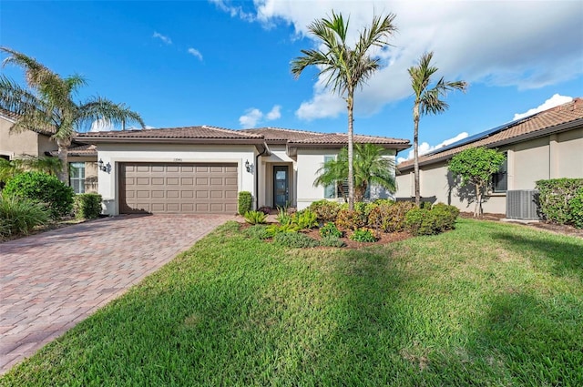 mediterranean / spanish home featuring a front yard and a garage