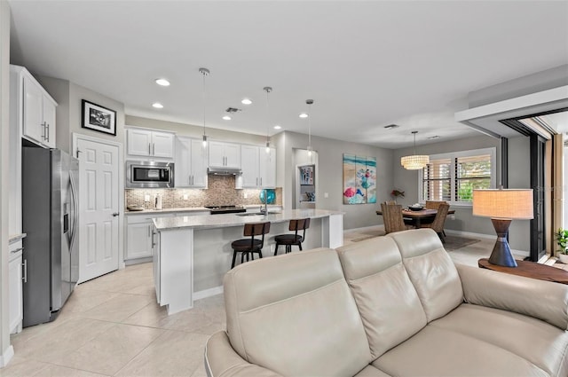 tiled living room featuring sink