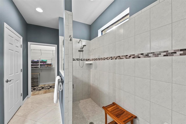 bathroom featuring tile patterned flooring and tiled shower