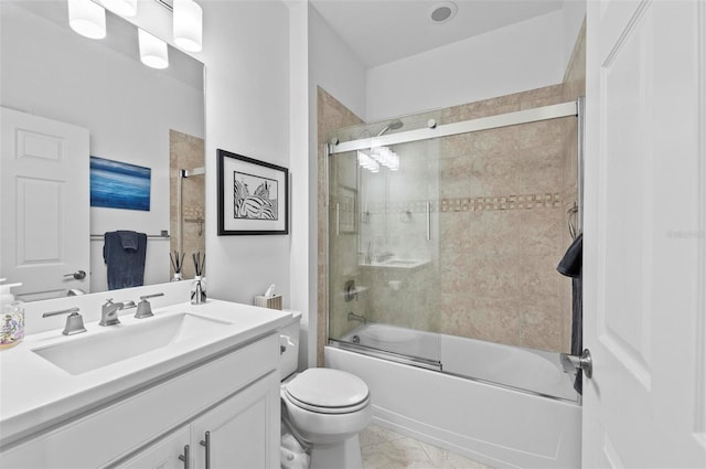 full bathroom featuring shower / bath combination with glass door, vanity, and toilet