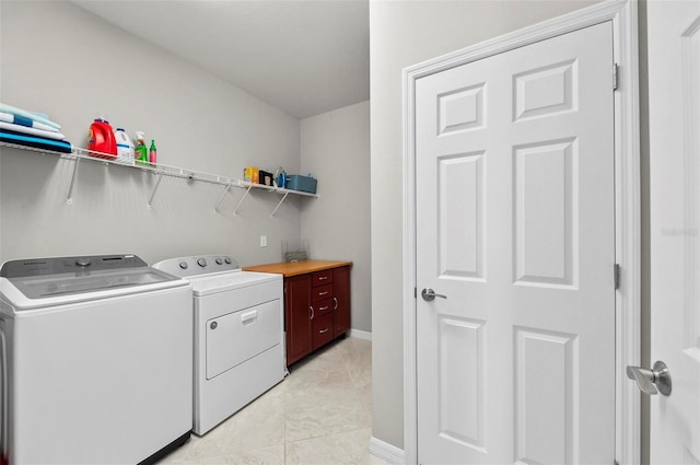 washroom featuring washer and dryer and light tile patterned flooring