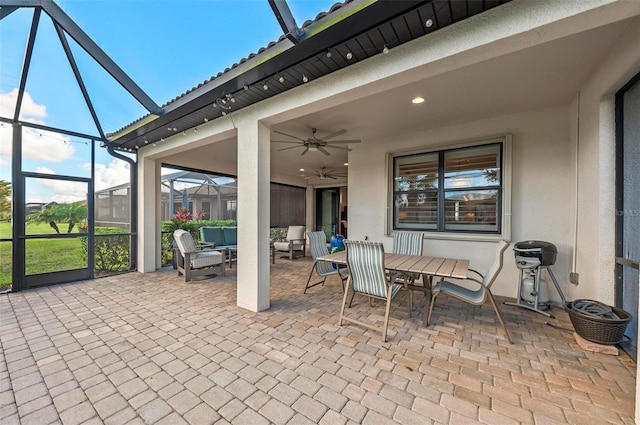 view of patio featuring a lanai, outdoor lounge area, and ceiling fan