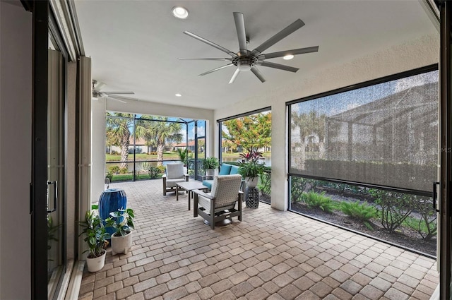 sunroom featuring ceiling fan