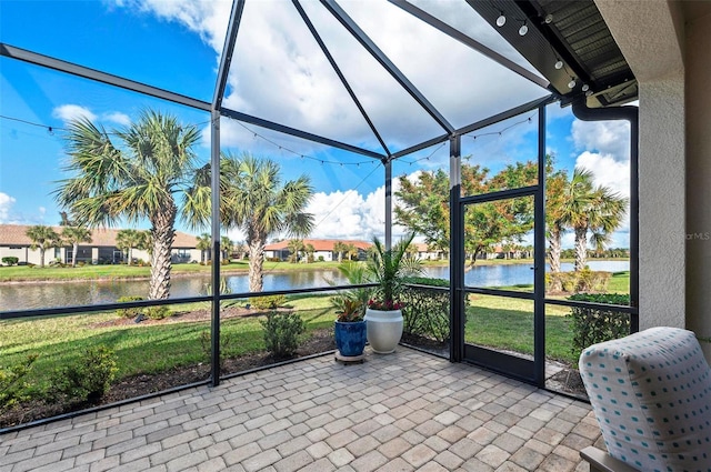 sunroom / solarium featuring a water view