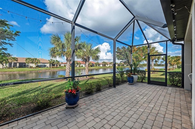 unfurnished sunroom with a water view