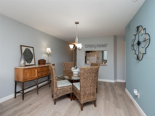 dining space with light hardwood / wood-style floors