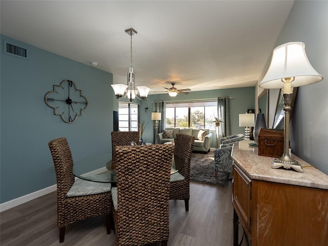 dining space with ceiling fan and dark wood-type flooring