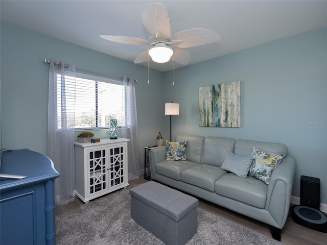 living room with dark hardwood / wood-style flooring and ceiling fan