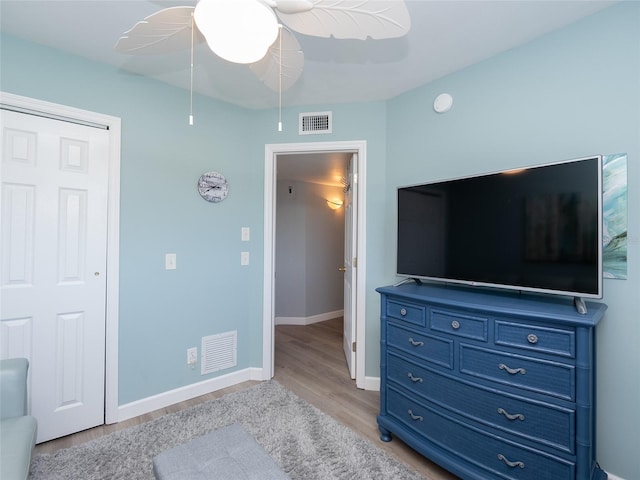 bedroom with light hardwood / wood-style floors and ceiling fan