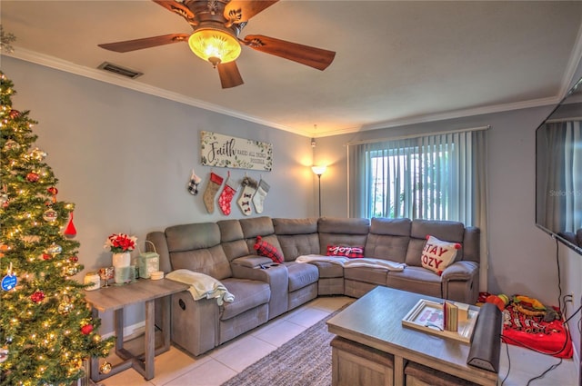 tiled living room with ceiling fan and ornamental molding