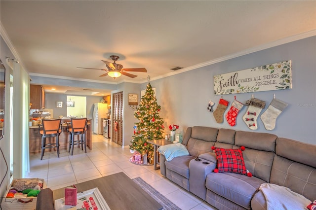 tiled living room featuring ceiling fan and ornamental molding